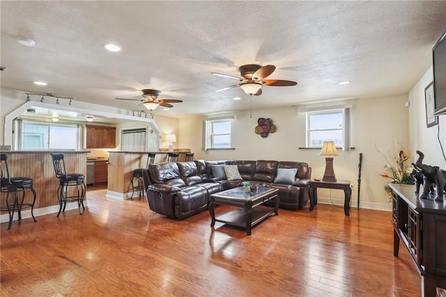 922 Lamanche St, New Orleans, LA 70117 - living room featuring ceiling fan, light wood-type flooring, recessed lighting, a textured ceiling, and baseboards