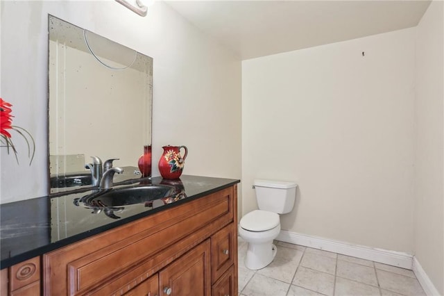922 Lamanche St, New Orleans, LA 70117 - half bathroom featuring baseboards, toilet, vanity, and tile patterned floors