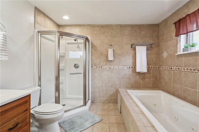 922 Lamanche St, New Orleans, LA 70117 - bathroom featuring a stall shower, a tub with jets, tile patterned flooring, vanity, and tile walls