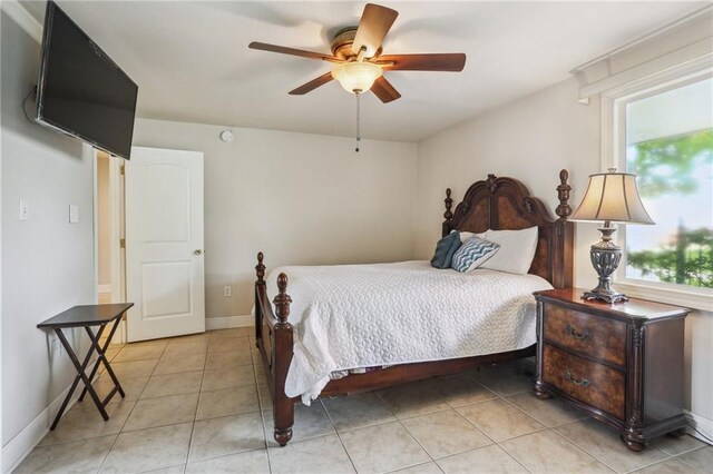 922 Lamanche St, New Orleans, LA 70117 - bedroom with light tile patterned floors, a ceiling fan, and baseboards