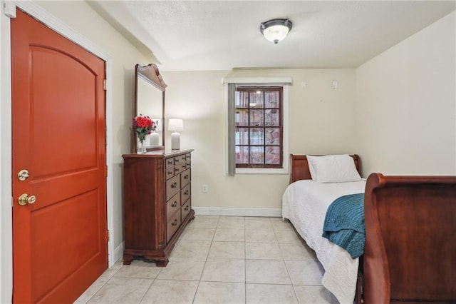 922 Lamanche St, New Orleans, LA 70117 - bedroom with baseboards, light tile patterned flooring, and a textured ceiling