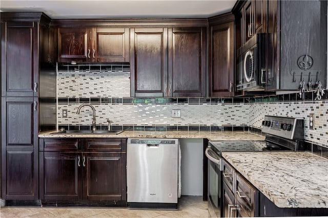 717 Magnolia Ave, La Place, LA 70068 - kitchen featuring stainless steel appliances, a sink, decorative backsplash, and dark brown cabinetry