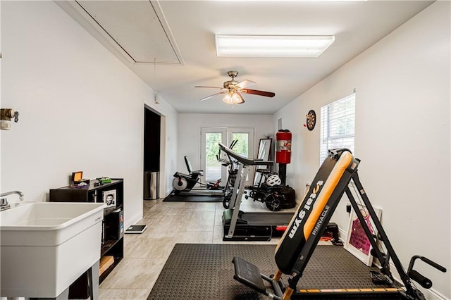 717 Magnolia Ave, La Place, LA 70068 - workout room with attic access, a sink, a ceiling fan, and baseboards