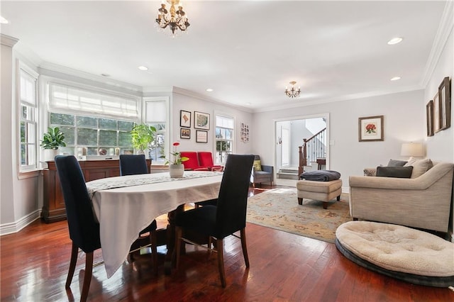 dining area with a chandelier, dark wood-type flooring, stairway, ornamental molding, and baseboards