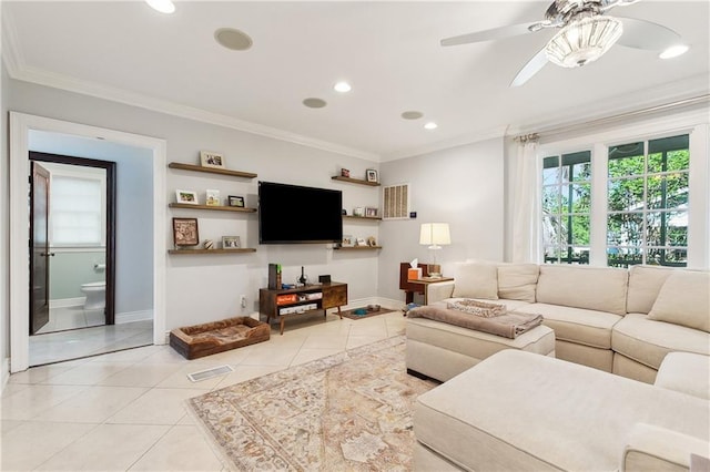 living room with light tile patterned floors, ceiling fan, baseboards, crown molding, and recessed lighting