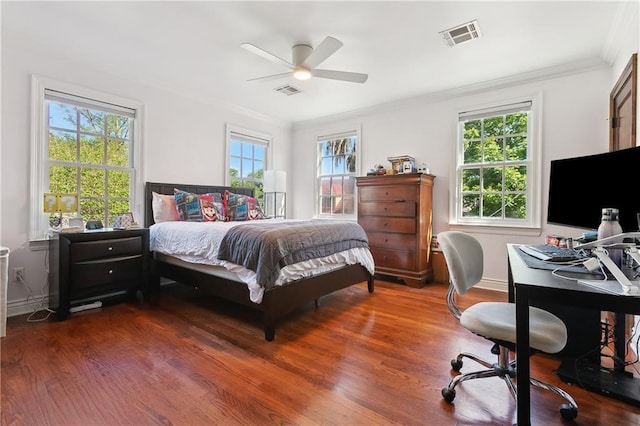 bedroom with crown molding, dark wood-type flooring, an office area, baseboards, and ceiling fan