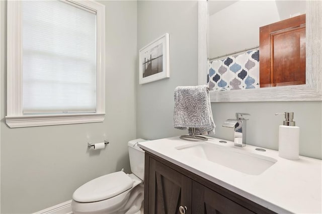 bathroom featuring toilet and vanity