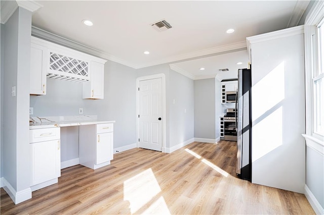 3827 Catherine Ave, Metairie, LA 70001 - kitchen featuring stainless steel appliances, white cabinets, light wood-style flooring, baseboards, and crown molding