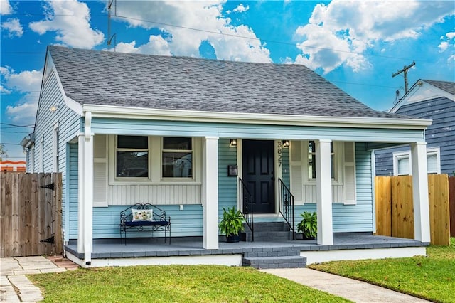 3827 Catherine Ave, Metairie, LA 70001 - bungalow featuring a porch, fence, and a shingled roof