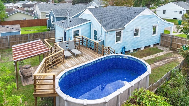 3827 Catherine Ave, Metairie, LA 70001 - view of swimming pool featuring a jacuzzi, a wooden deck, a fenced backyard, and a residential view
