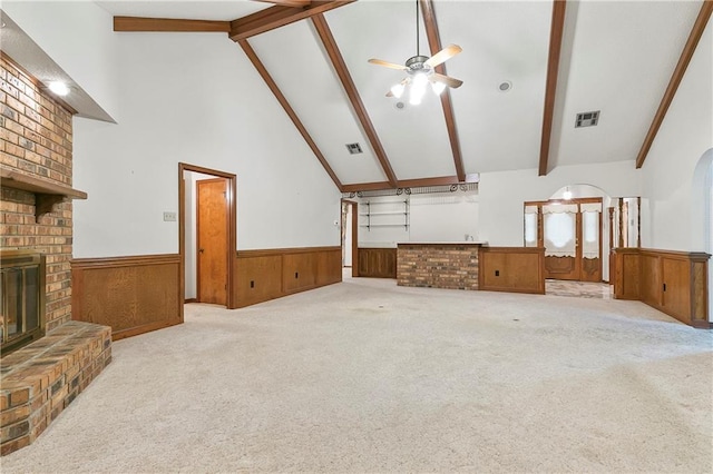 1 Fairfax Ct, Marrero, LA 70072 - unfurnished living room featuring beam ceiling, a wainscoted wall, ceiling fan, high vaulted ceiling, and a fireplace