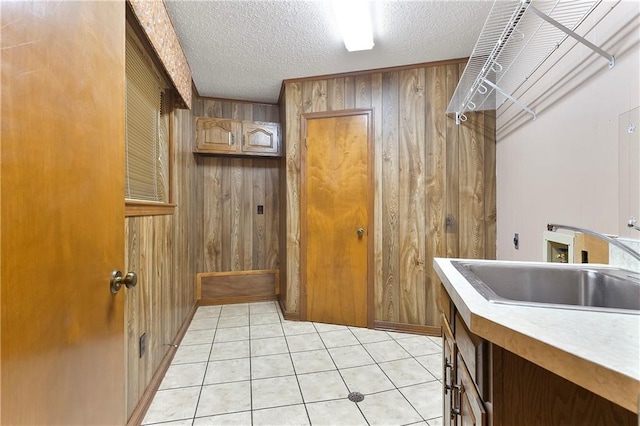 1 Fairfax Ct, Marrero, LA 70072 - laundry area with hookup for a washing machine, wood walls, electric dryer hookup, a textured ceiling, and light tile patterned flooring