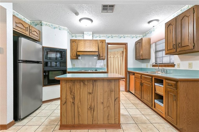 1 Fairfax Ct, Marrero, LA 70072 - kitchen featuring black appliances, a sink, wallpapered walls, a center island, and light tile patterned floors