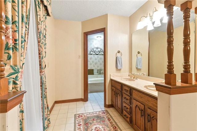 1 Fairfax Ct, Marrero, LA 70072 - bathroom with tile patterned flooring, wallpapered walls, a textured ceiling, a bathtub, and double vanity