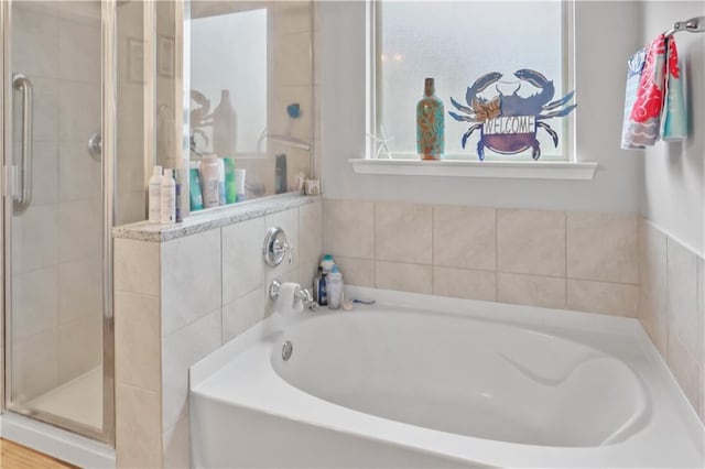 full bath with a stall shower and a bath