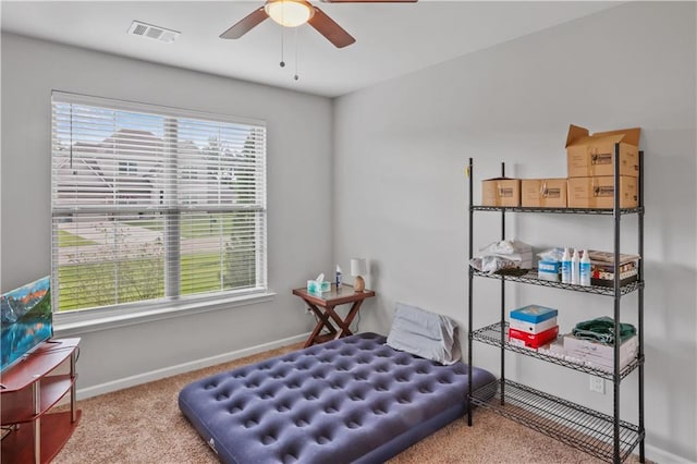 living area featuring carpet floors, a ceiling fan, and baseboards