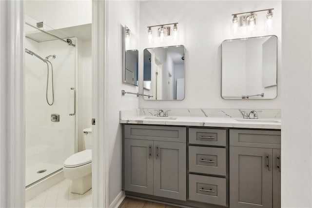 1750 Saint Charles Ave Unit 531, New Orleans, LA 70130 - bathroom featuring a shower stall, toilet, and double vanity