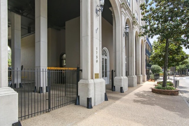 entrance to property with fence and stucco siding