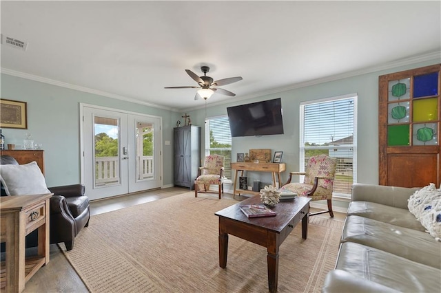 4102 Pennsylvania St, Bay Saint Louis, MS 39520 - living room featuring french doors, ornamental molding, light wood finished floors, and ceiling fan