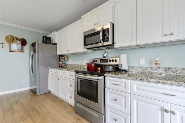 4102 Pennsylvania St, Bay Saint Louis, MS 39520 - kitchen featuring stainless steel appliances, white cabinets, crown molding, light wood-style flooring, and light stone countertops