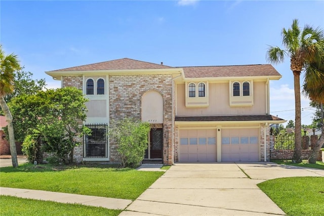 view of front of house featuring driveway, a front yard, and an attached garage