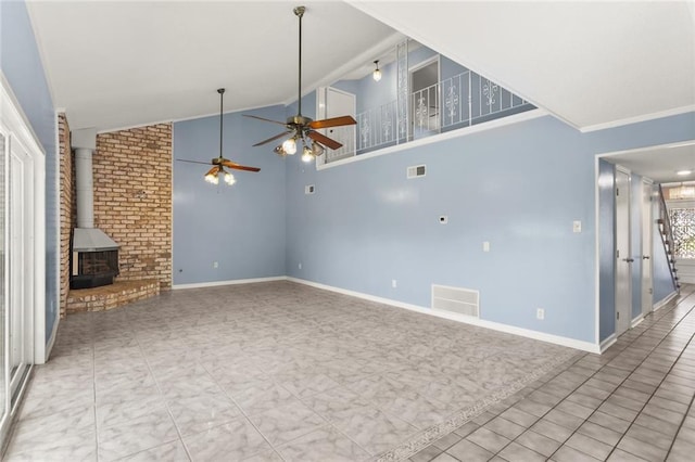 unfurnished living room featuring ceiling fan, a wood stove, vaulted ceiling, baseboards, and ornamental molding
