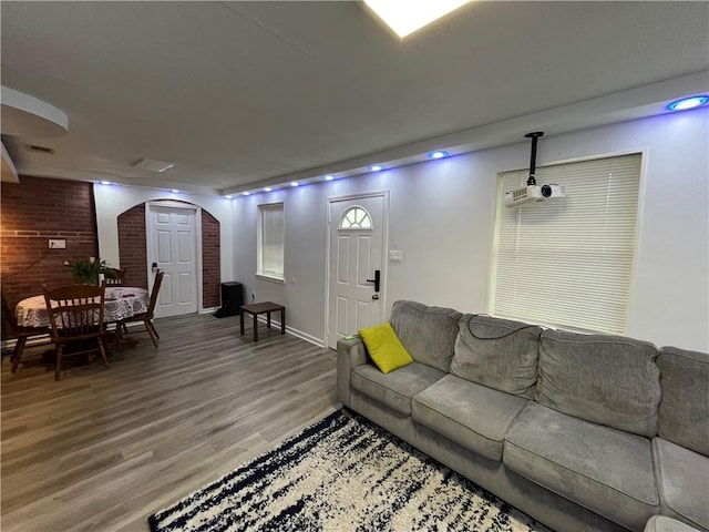 3278 Glen Eagle Ln, Kenner, LA 70065 - living room with arched walkways, light wood finished floors, and baseboards