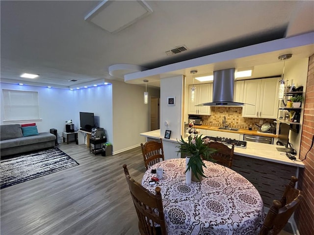 3278 Glen Eagle Ln, Kenner, LA 70065 - dining room featuring dark wood-style floors and baseboards
