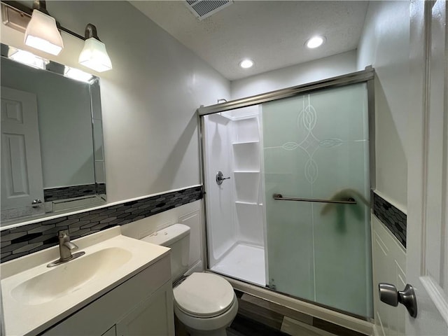 3278 Glen Eagle Ln, Kenner, LA 70065 - full bathroom with a shower stall, toilet, vanity, recessed lighting, and wainscoting