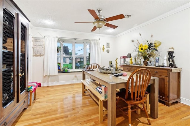 3931 S Post Oak Ave, New Orleans, LA 70131 - dining area featuring light wood-type flooring, crown molding, a ceiling fan, and baseboards