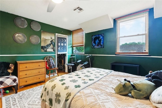 3931 S Post Oak Ave, New Orleans, LA 70131 - bedroom with wood finished floors, multiple windows, and a ceiling fan