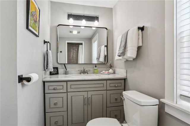 bathroom with toilet and vanity
