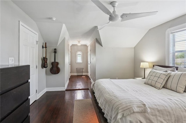 bedroom with hardwood / wood-style floors, multiple windows, vaulted ceiling, baseboards, and a ceiling fan