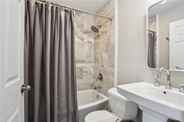full bathroom featuring a sink, toilet, and shower / tub combo with curtain