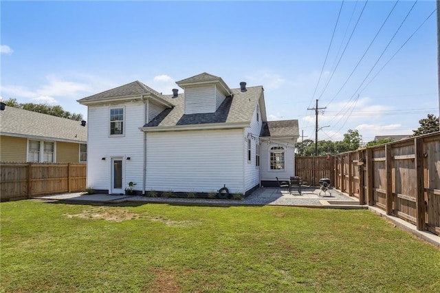 back of house featuring a patio area and a shingled roof