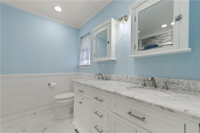 11020 Delaware St, Bay Saint Louis, MS 39520 - bathroom with marble finish floors, crown molding, toilet, double vanity, and wainscoting