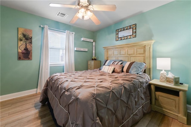 11020 Delaware St, Bay Saint Louis, MS 39520 - bedroom with hardwood / wood-style flooring, a ceiling fan, and baseboards