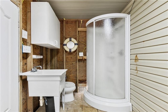11020 Delaware St, Bay Saint Louis, MS 39520 - full bath with wooden walls, a stall shower, and toilet