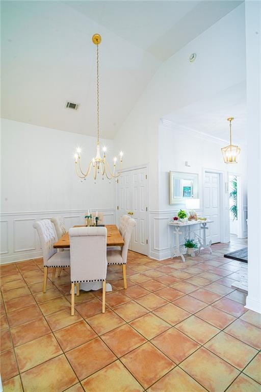 1413 Royal Palm Dr Unit A, Slidell, LA 70458 - dining area with a chandelier, high vaulted ceiling, a decorative wall, a wainscoted wall, and ornamental molding