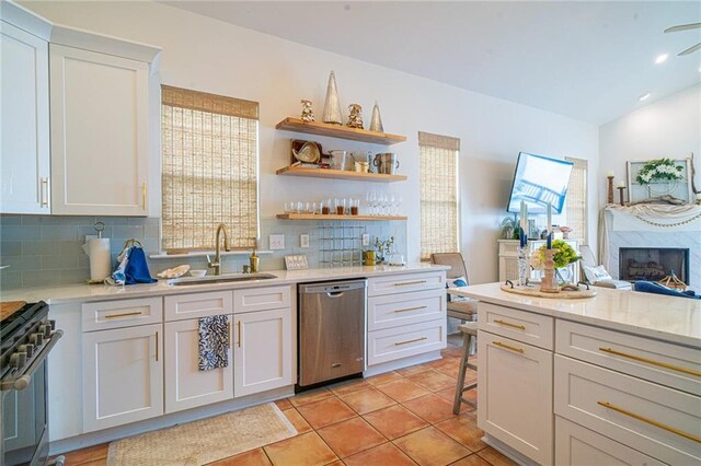 1413 Royal Palm Dr Unit A, Slidell, LA 70458 - kitchen with stainless steel appliances, a sink, backsplash, white cabinets, and light tile patterned floors