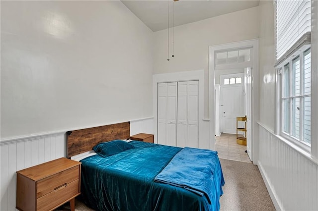 512830 Constance St, New Orleans, LA 70115 - bedroom with multiple windows, wainscoting, a closet, and carpet