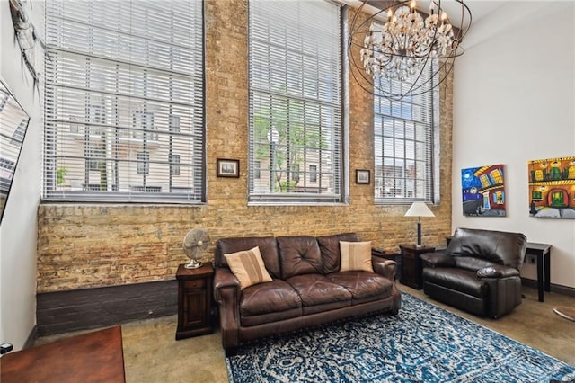 920 Poeyfarre St Unit 109, New Orleans, LA 70130 - living room featuring healthy amount of natural light, a chandelier, a high ceiling, carpet, and baseboards