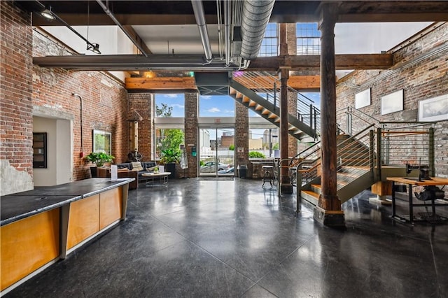 920 Poeyfarre St Unit 109, New Orleans, LA 70130 - community lobby featuring a high ceiling, brick wall, and stairway