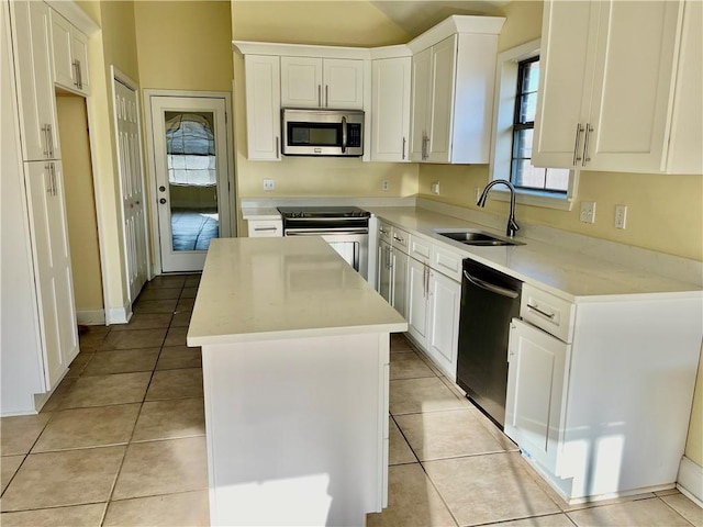 35 Derek Ln, La Place, LA 70068 - kitchen with appliances with stainless steel finishes, a kitchen island, light countertops, and white cabinetry