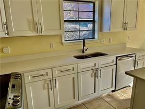 35 Derek Ln, La Place, LA 70068 - kitchen featuring dishwasher, a sink, light countertops, light tile patterned floors, and white cabinetry