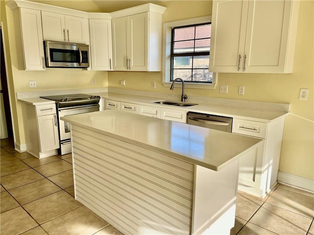 35 Derek Ln, La Place, LA 70068 - kitchen with appliances with stainless steel finishes, light tile patterned floors, white cabinetry, a center island, and light countertops