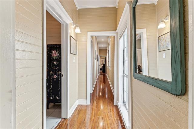 525 S Telemachus St, New Orleans, LA 70119 - hall with ornamental molding, wood finished floors, and baseboards