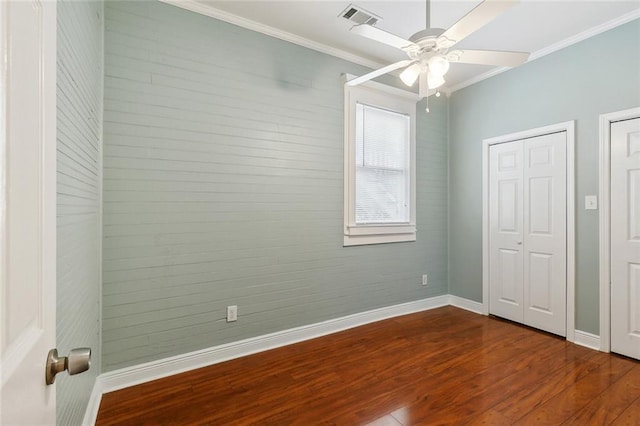 525 S Telemachus St, New Orleans, LA 70119 - unfurnished bedroom featuring baseboards, dark wood-style flooring, crown molding, and ceiling fan