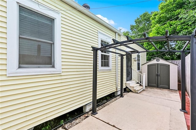 525 S Telemachus St, New Orleans, LA 70119 - view of property exterior featuring a storage shed, a patio, fence, an outbuilding, and entry steps