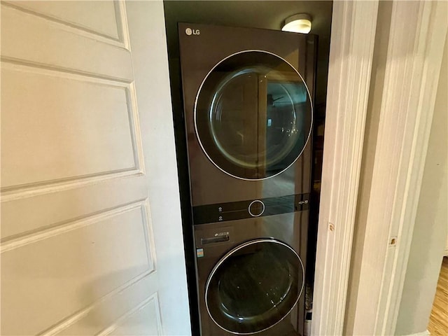 500 Lake Marina Ave Unit 408, New Orleans, LA 70124 - laundry room featuring stacked washing machine and dryer and wood finished floors
